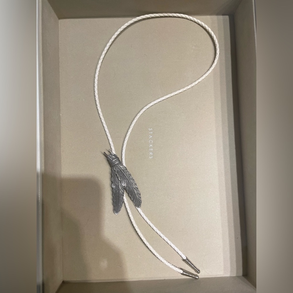 Tied Feathers Bolo Tie on White Braided Leather
